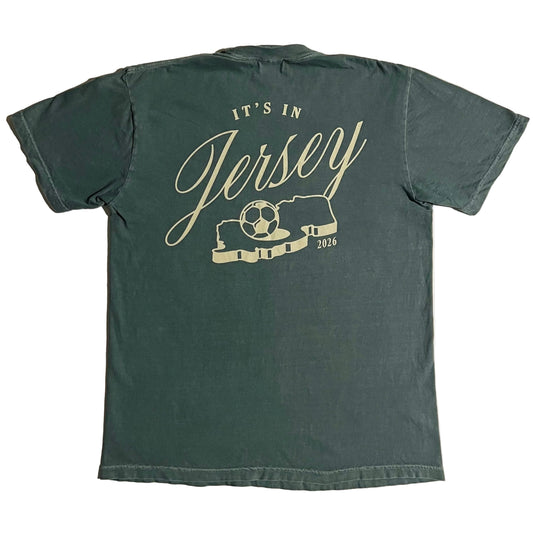 Green t-shirt with It's in Jersey logo and state with soccer ball graphic on back