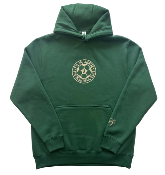 Green hoodie with a It's In Jersey The Beautiful Game logo centered on front. Brand logo on sleeve