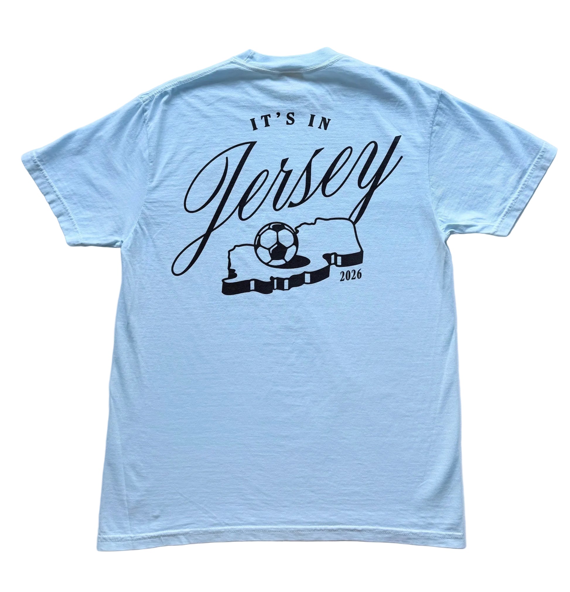 Light blue t-shirt with It's in Jersey logo and state with soccer ball graphic on back