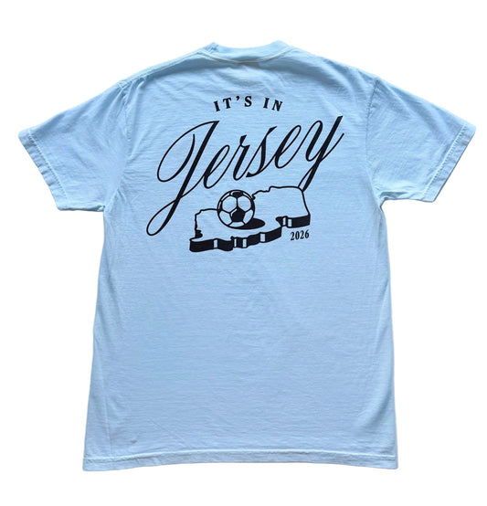 Light blue t-shirt with It's in Jersey logo and state with soccer ball graphic on back